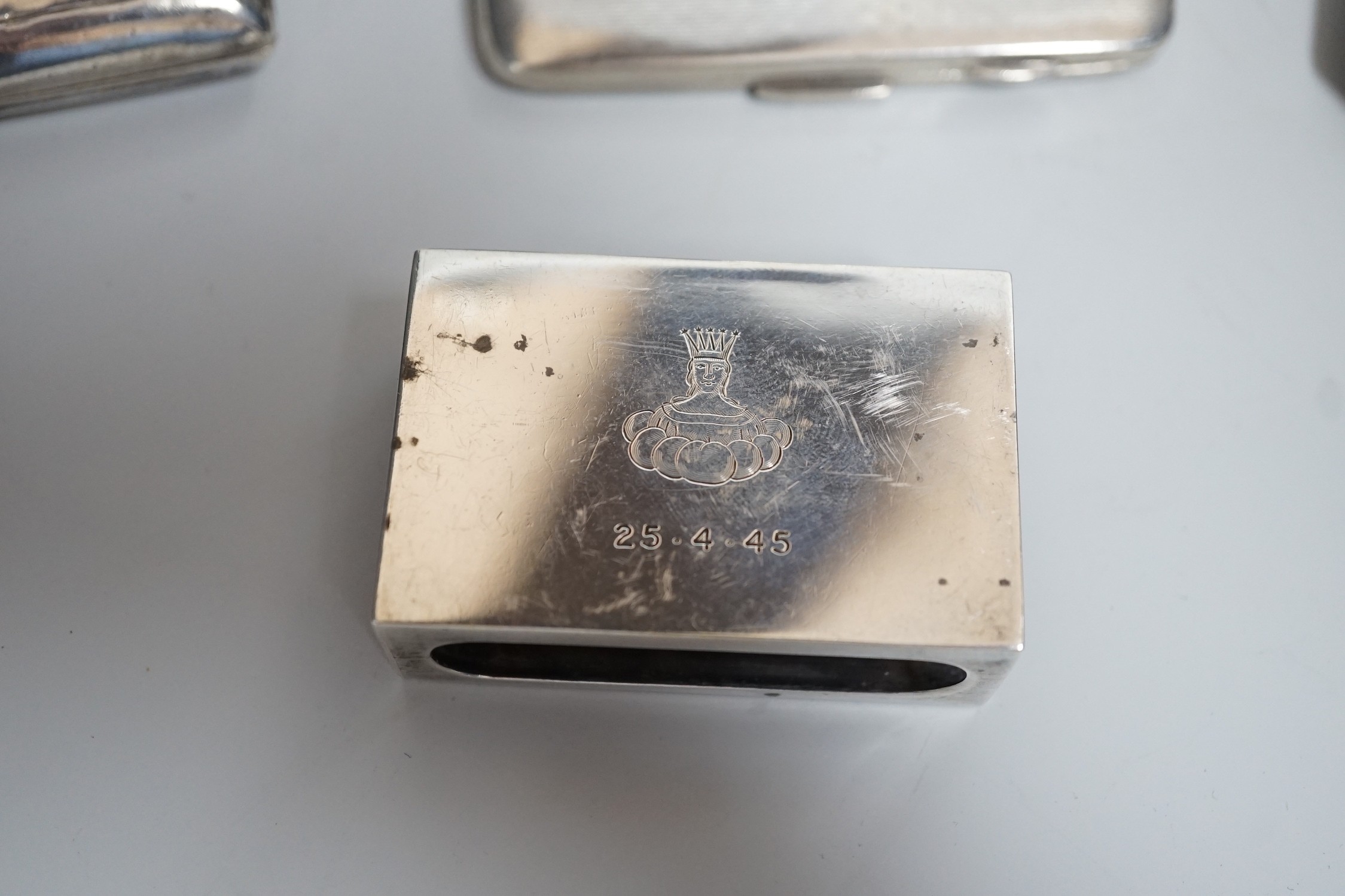 A George V silver oval teapot, Birmingham, 1913, three silver cigarette cases and a silver matchbox holder, gross weight 29oz.